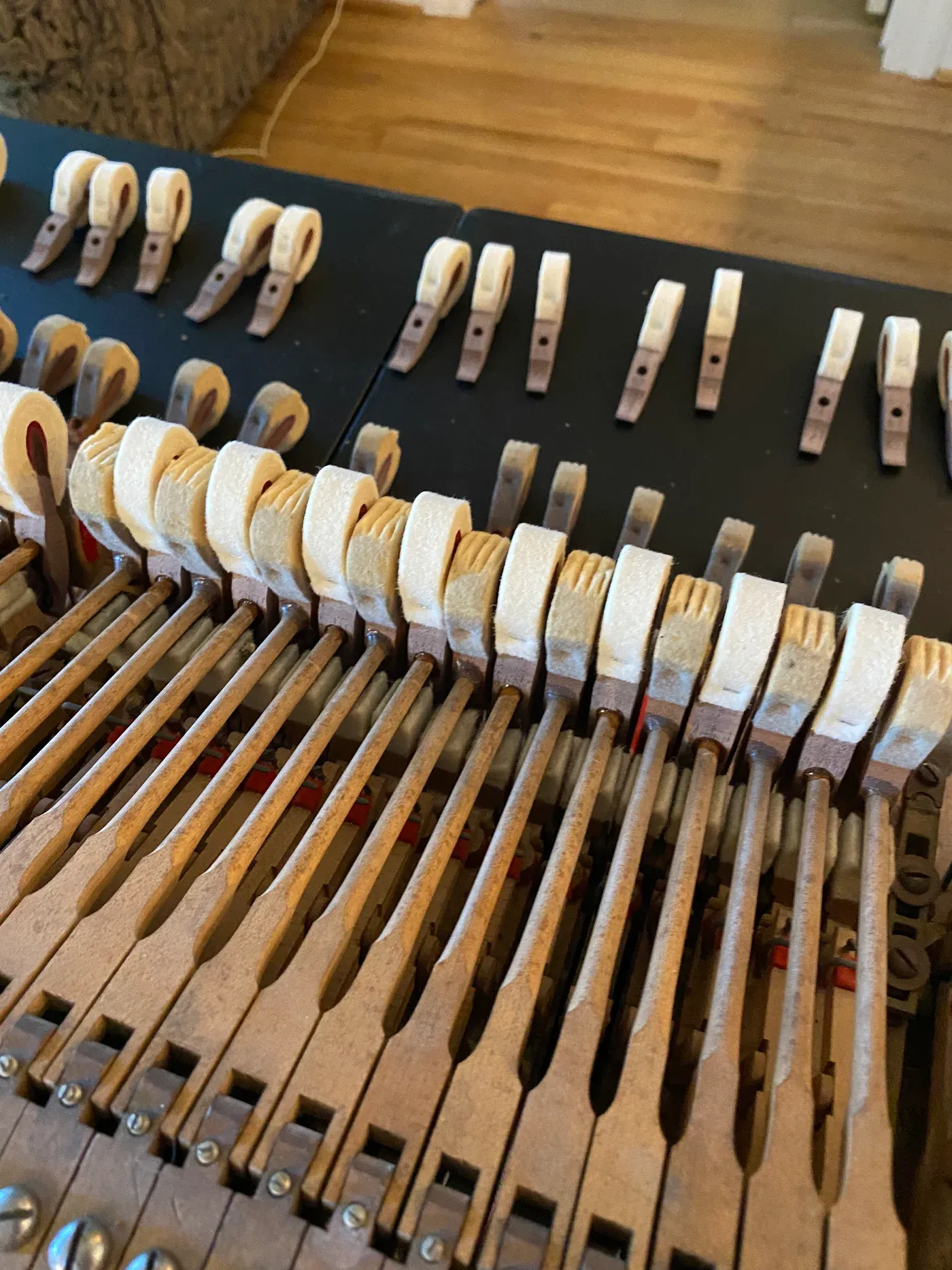 Close view of piano hammers and action parts during service