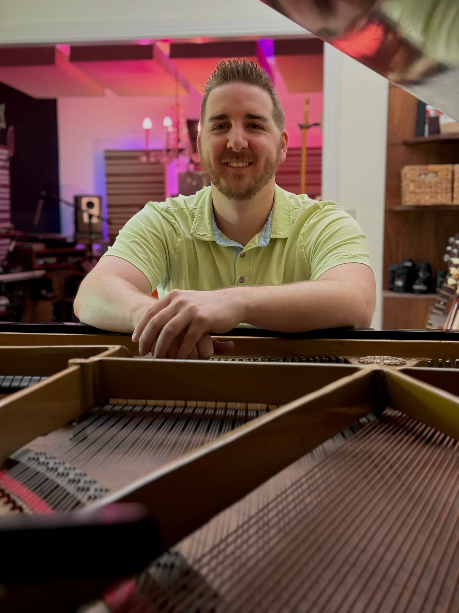Portrait of Pierce O’Brien seated in front of a grand piano