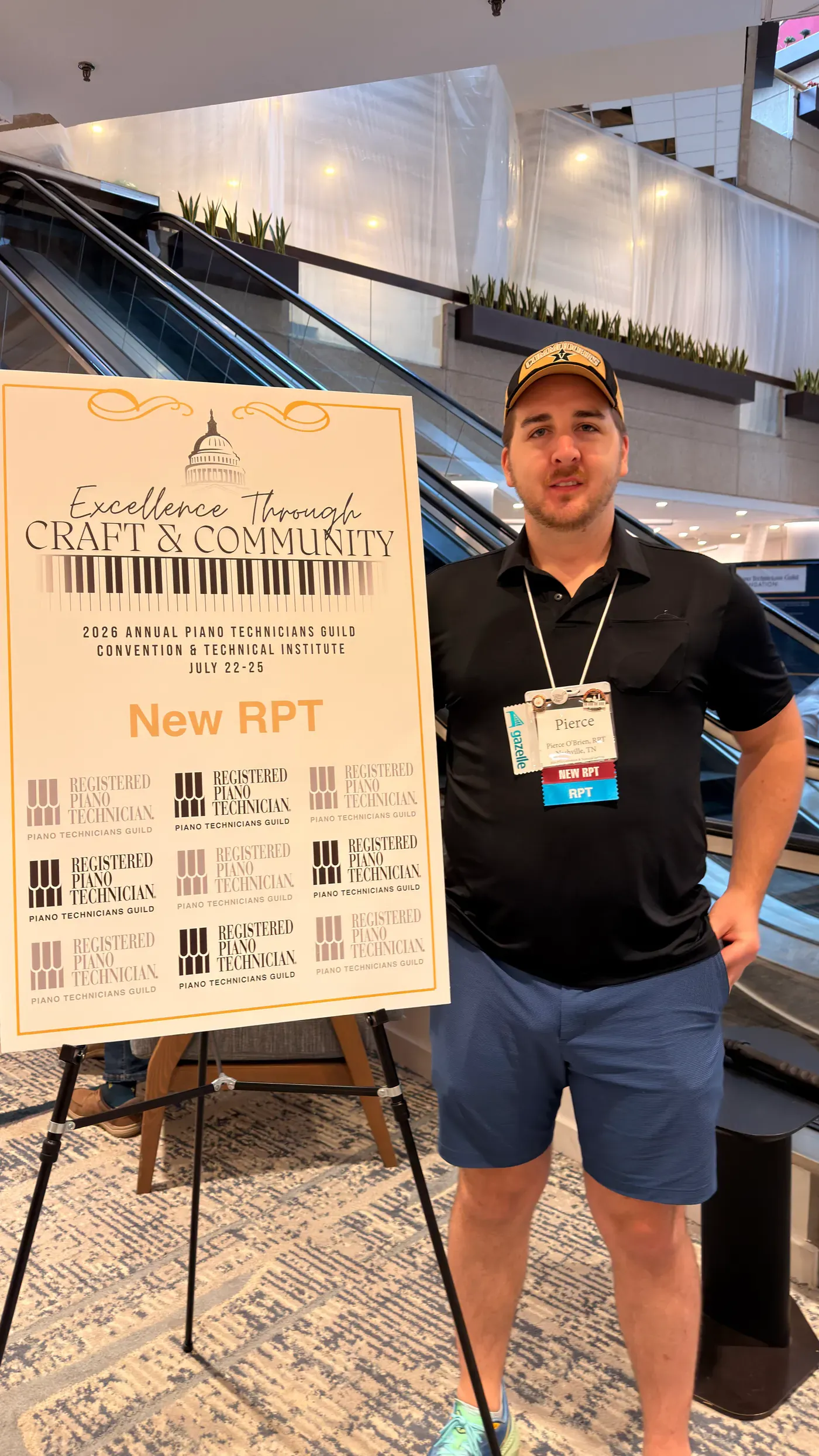 Pierce O’Brien beside an event display at a piano-technician convention