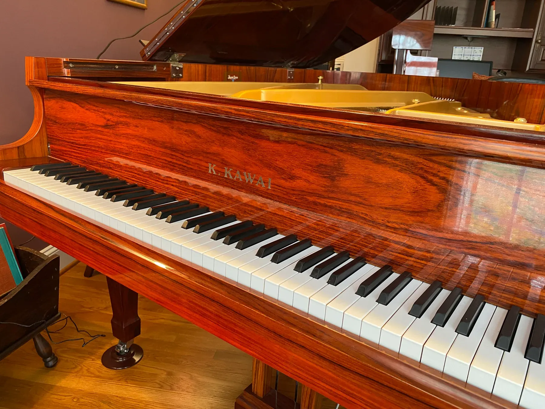 A polished Kawai grand piano with its lid open